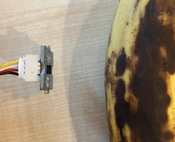 The rangefinder on the back of the time of flight sensor pointing at a banana