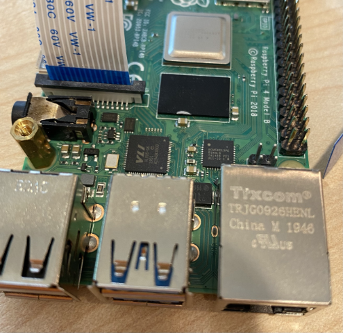 The ribbon cable connected to the camera socket on the Pi