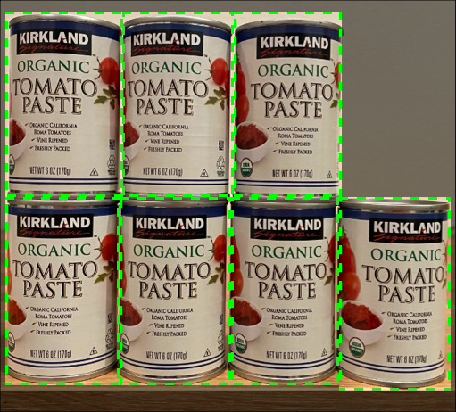 7 cans of tomato paste on a shelf, 4 on the top row, 3 on top